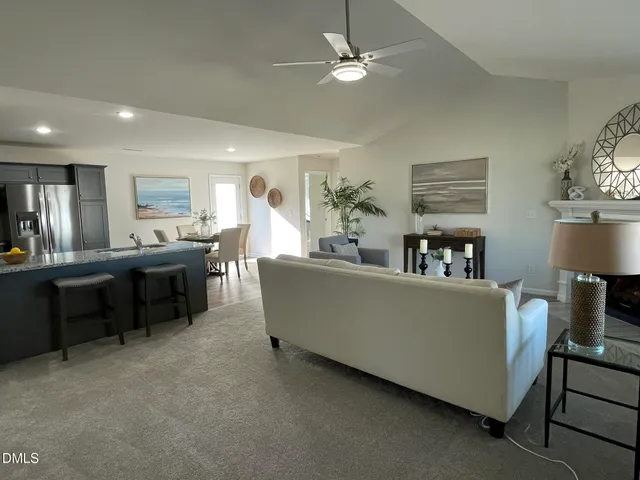 a living room with furniture and a chandelier