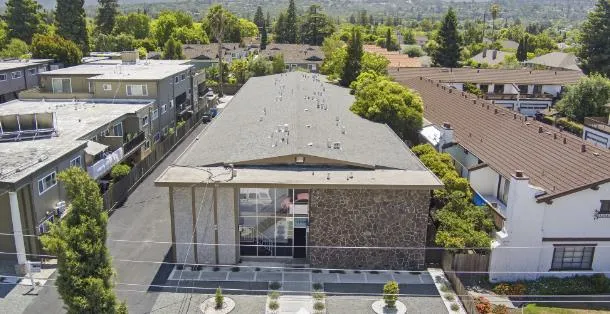 an aerial view of a house with a garden and plants