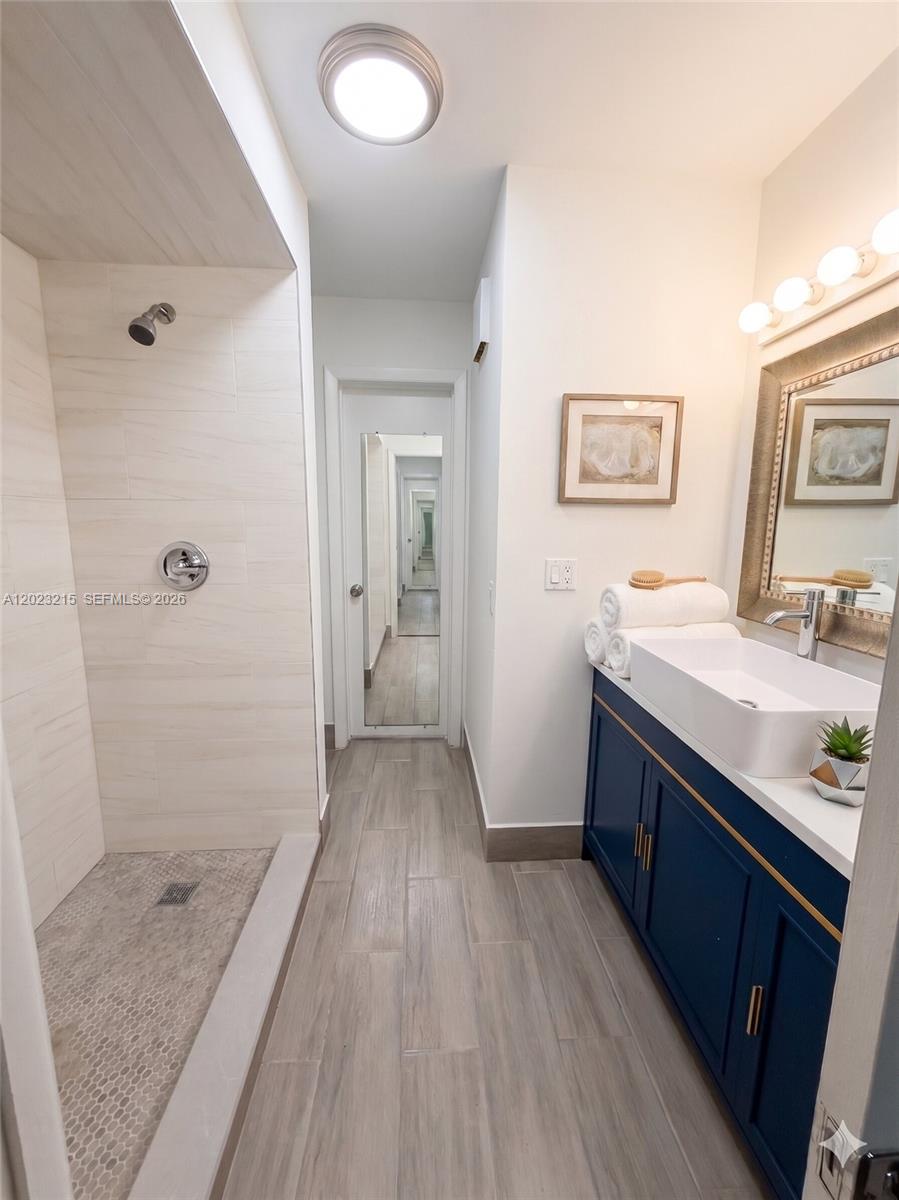 13 Southwest 3rd Street, Unit 13 Pompano Beach, FL 33060 - Photo 23 of 44 a bathroom with a sink and a mirror
