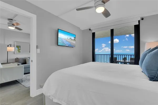 a bedroom with a bed and a large window