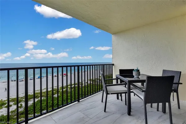 a view of a chairs and table in the balcony
