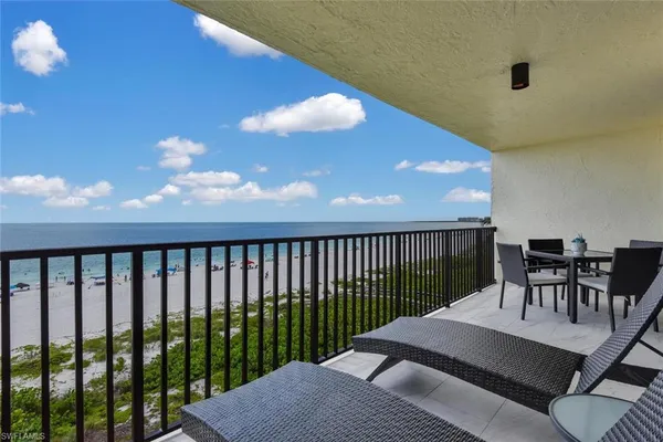 a balcony with table and chairs
