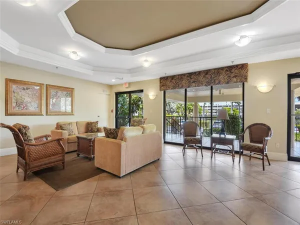 a living room with furniture and large windows