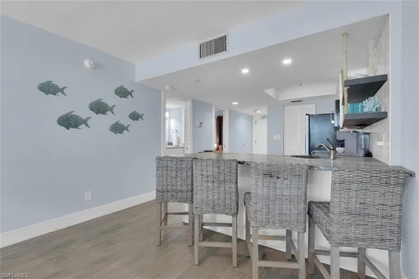 a dining room with furniture and a chandelier