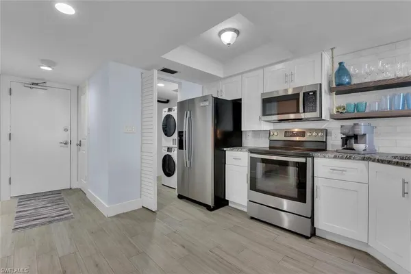 a kitchen with stainless steel appliances a refrigerator stove and microwave