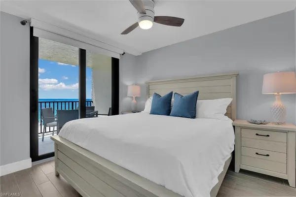 a bedroom with a large bed and a large window
