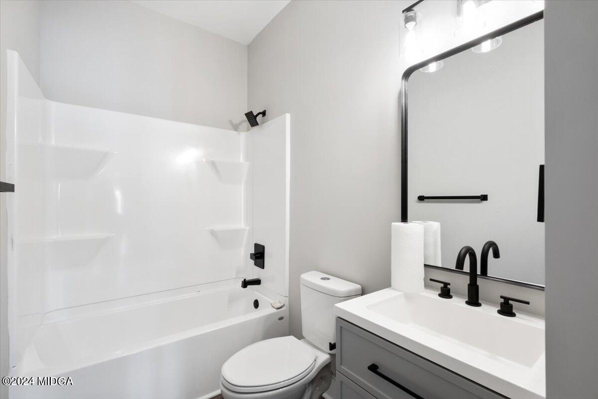 138 Towaliga Road Forsyth, GA 31029 - Photo 14 of 25 a bathroom with a sink a toilet and shower
