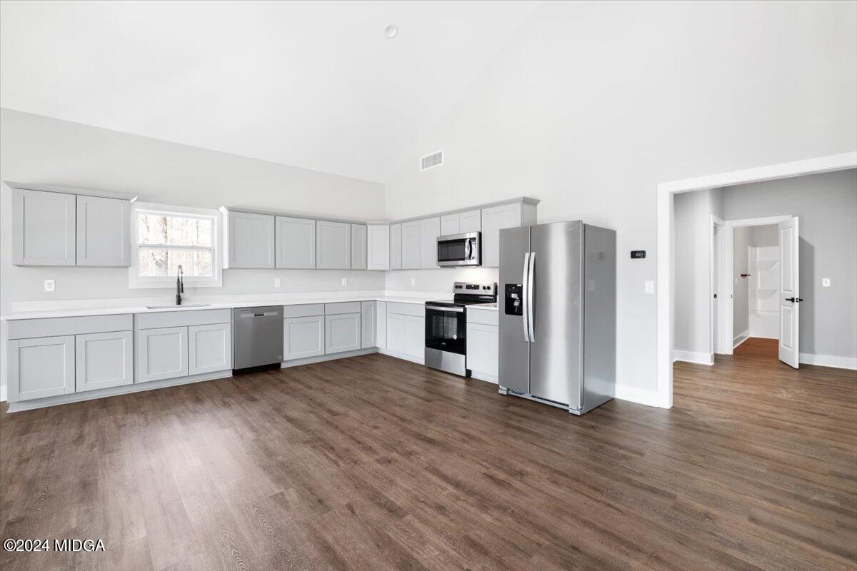 138 Towaliga Road Forsyth, GA 31029 - Photo 5 of 25 a view of kitchen with stainless steel appliances kitchen island wooden floors and white cabinets