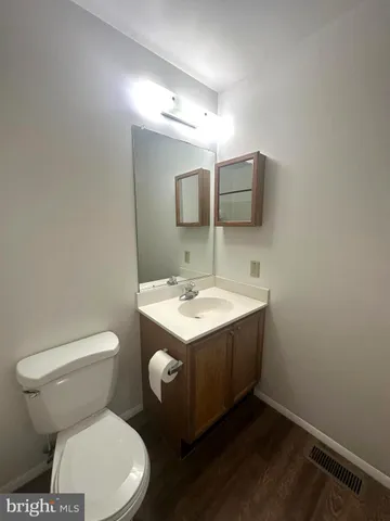a white toilet and tub next to a bathroom sink