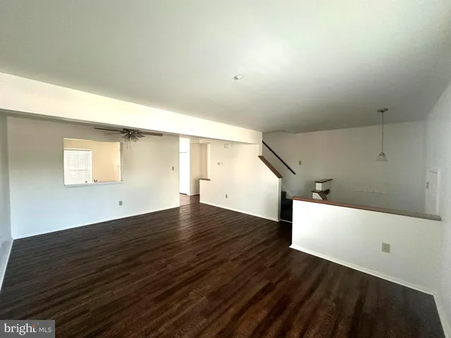 a view of a livingroom with furniture and an empty room