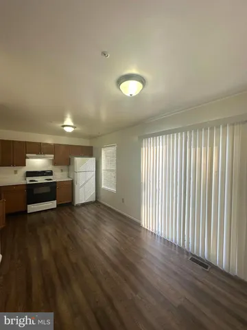 a kitchen with a refrigerator and a stove top oven