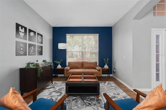 a dining room with furniture a rug and wooden floor