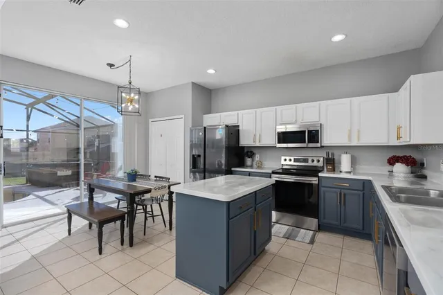 a kitchen with stainless steel appliances granite countertop a sink and dishwasher a stove top oven with white cabinets