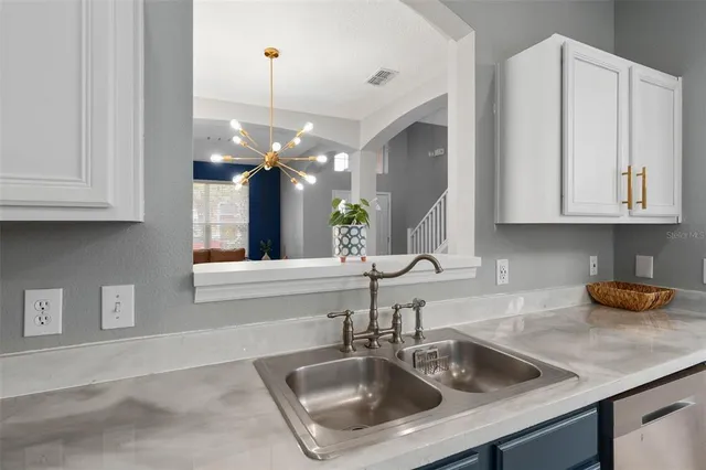 a living room with furniture a flat screen tv and a large window