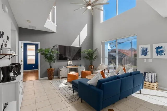 a bedroom with a bed flat screen tv and a large window