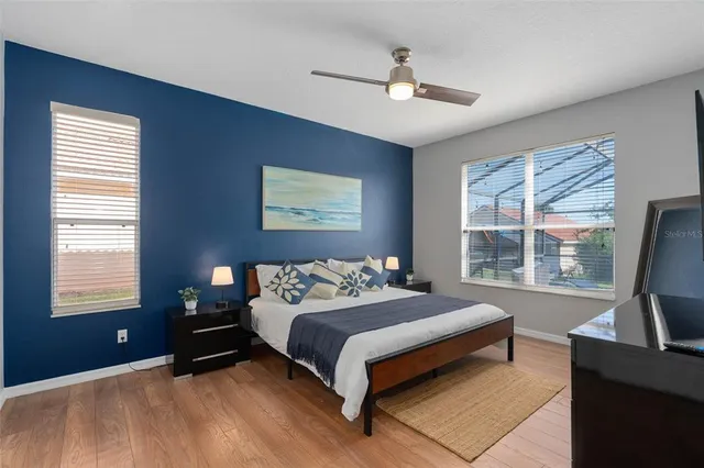 a bedroom with a bed and a painting on the wall