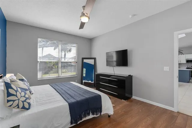 a bathroom with a granite countertop sink a large mirror and a bathtub