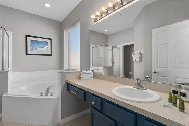 a spacious bathroom with a bathtub and a sink
