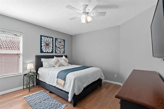 a bedroom with a large bed and a window