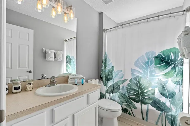 a bedroom with two beds and a chandelier