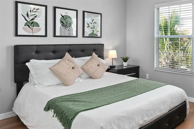 a bedroom with a bed and a window