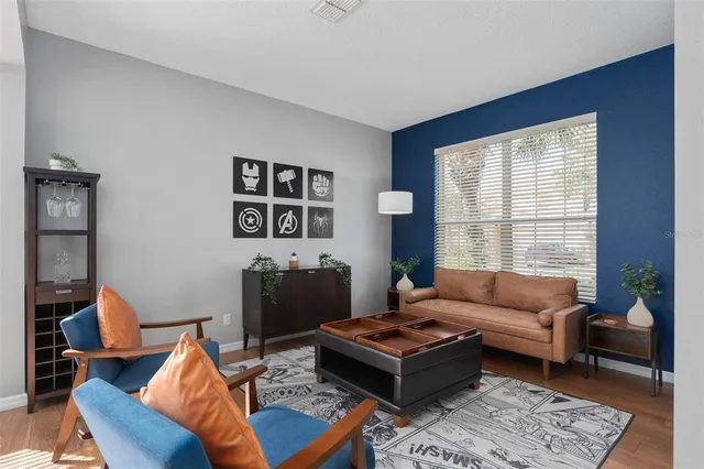 a living room with a balcony and a potted plant