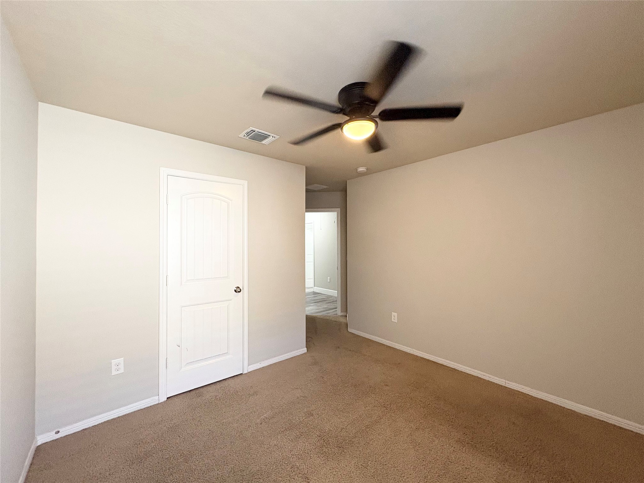 11708 Cambrian Road Manor, TX 78653 - Photo 17 of 31 A comfortable bedroom features carpet flooring and a ceiling fan, offering a tranquil retreat.