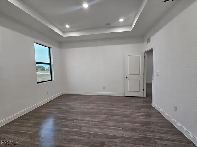 an empty room with closet and wooden floor