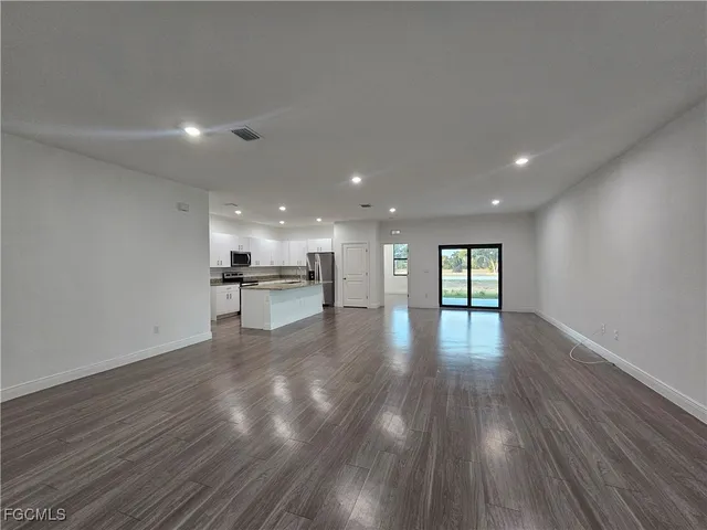 a view of kitchen with kitchen island and stainless steel appliances