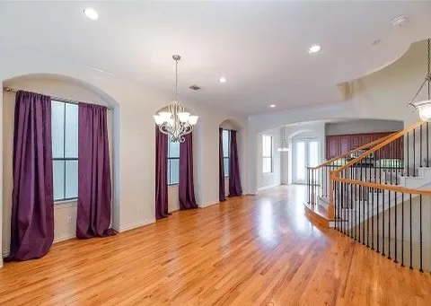 a view of a room with a chandelier and living room view