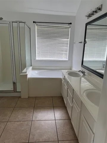 a bathroom with a sink a bathtub and a window