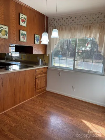 a kitchen with stainless steel appliances granite countertop a granite counter tops and a wooden floors