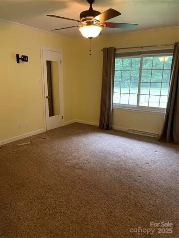 an empty room with a empty space and a ceiling fan