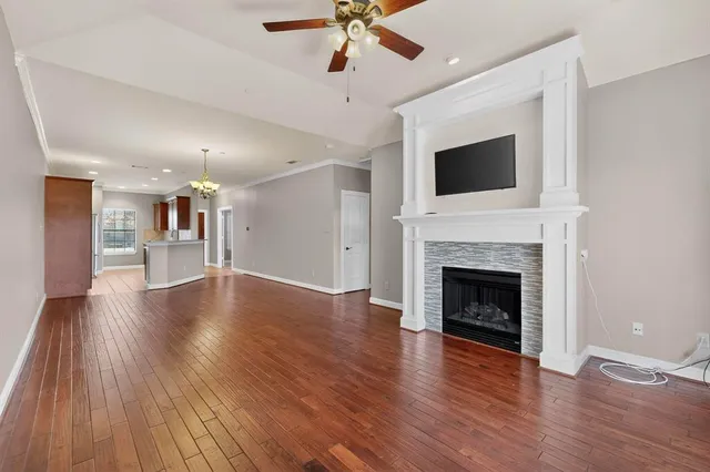 a view of a livingroom with a fireplace a ceiling fan and fireplace