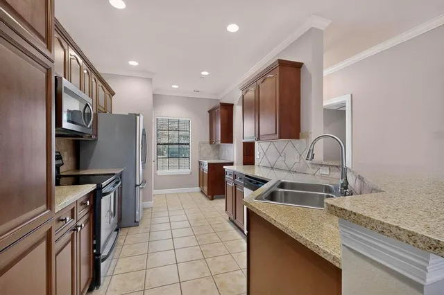 a kitchen with granite countertop a sink and a stove top oven