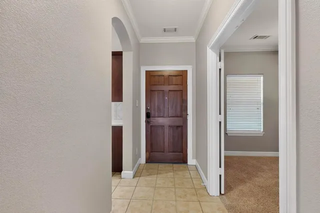 a view of a hallway with closet and a bathroom