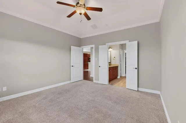 a view of a room with a ceiling fan