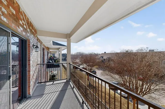 a view of a balcony with furniture and city view
