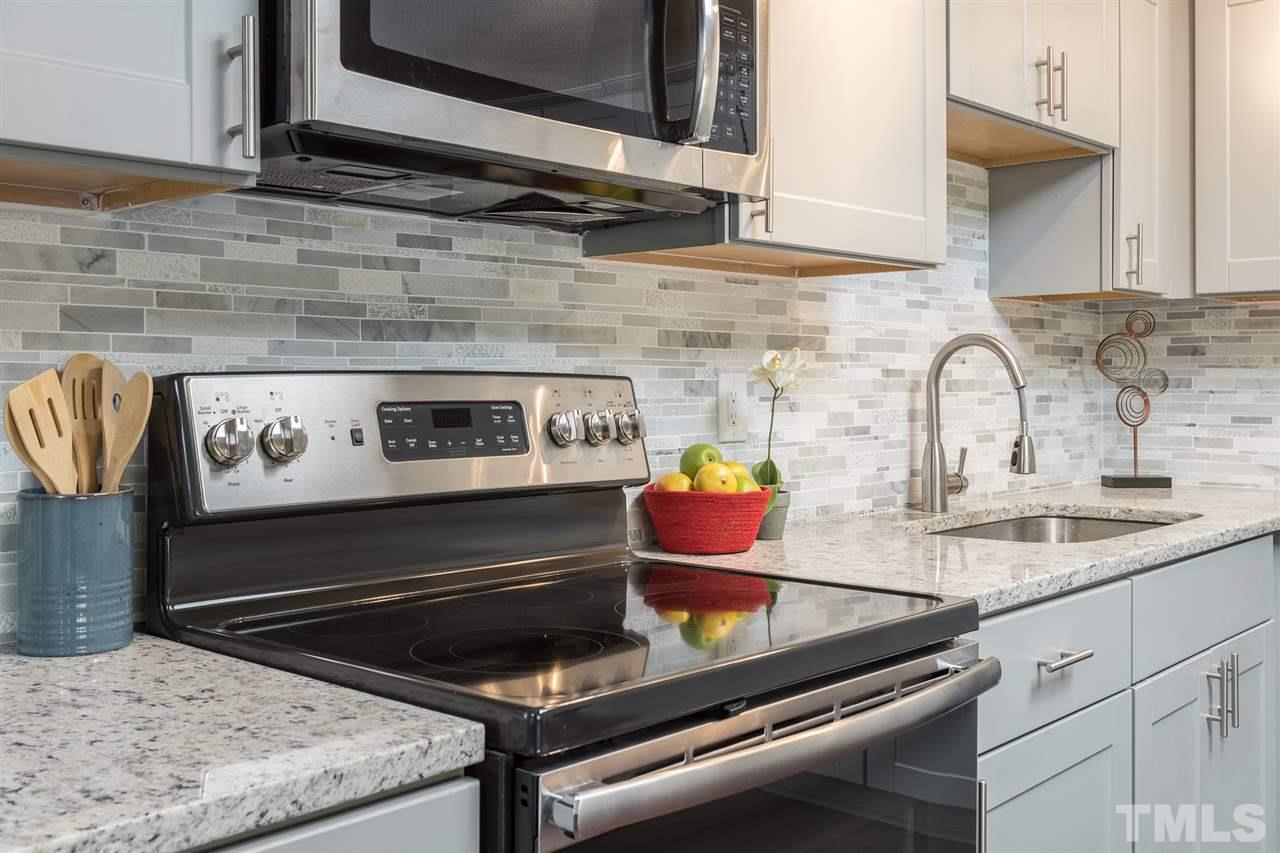 4907 Brentwood Road Durham, NC 27713 - Photo 12 of 27 a stove top oven sitting inside of a kitchen