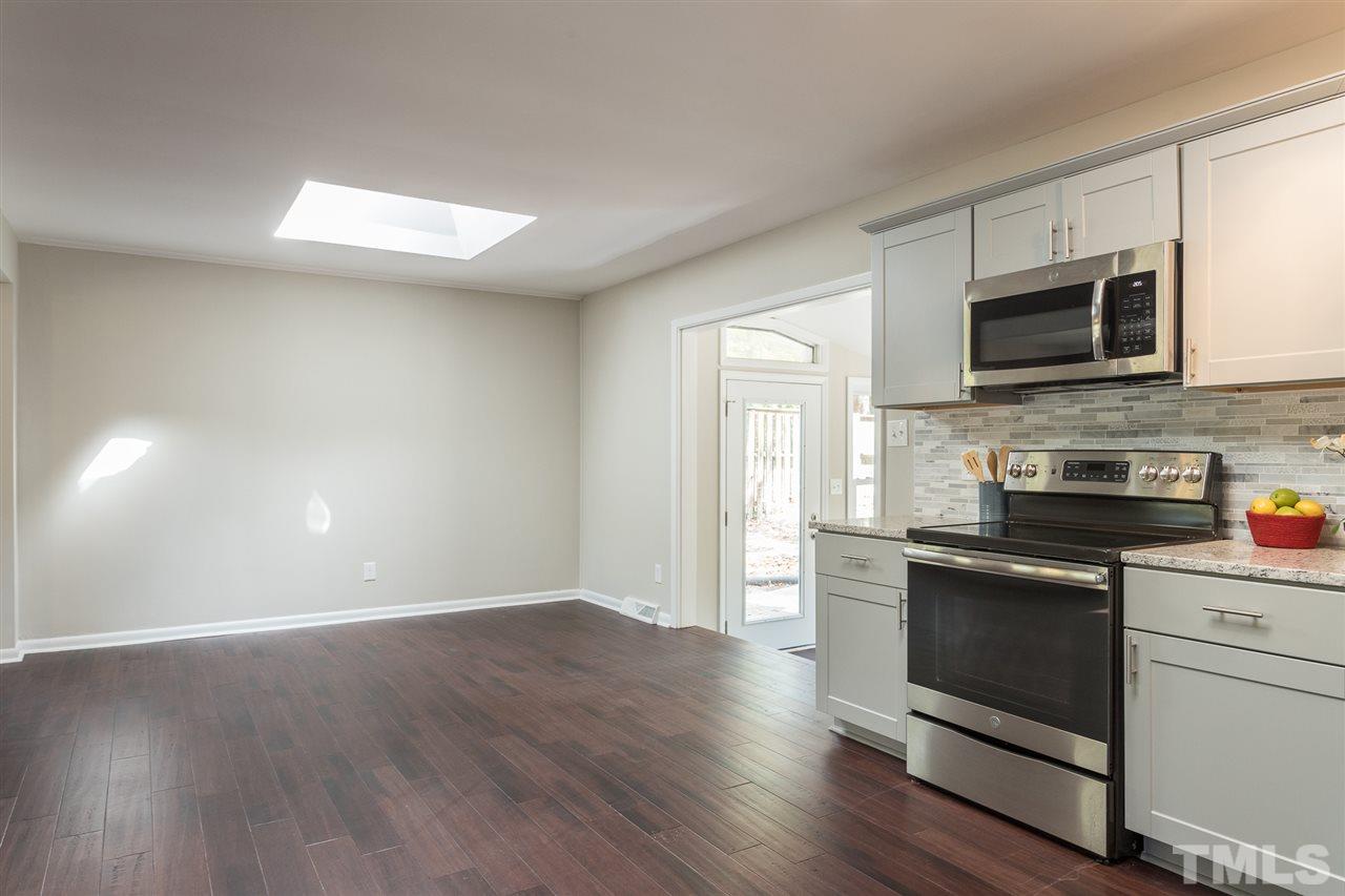 4907 Brentwood Road Durham, NC 27713 - Photo 13 of 27 a kitchen with stainless steel appliances granite countertop a stove a sink and a microwave