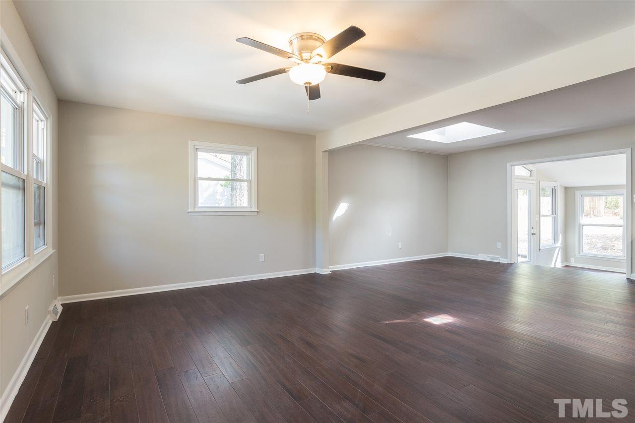 4907 Brentwood Road Durham, NC 27713 - Photo 3 of 27 a view of an empty room with wooden floor and a window