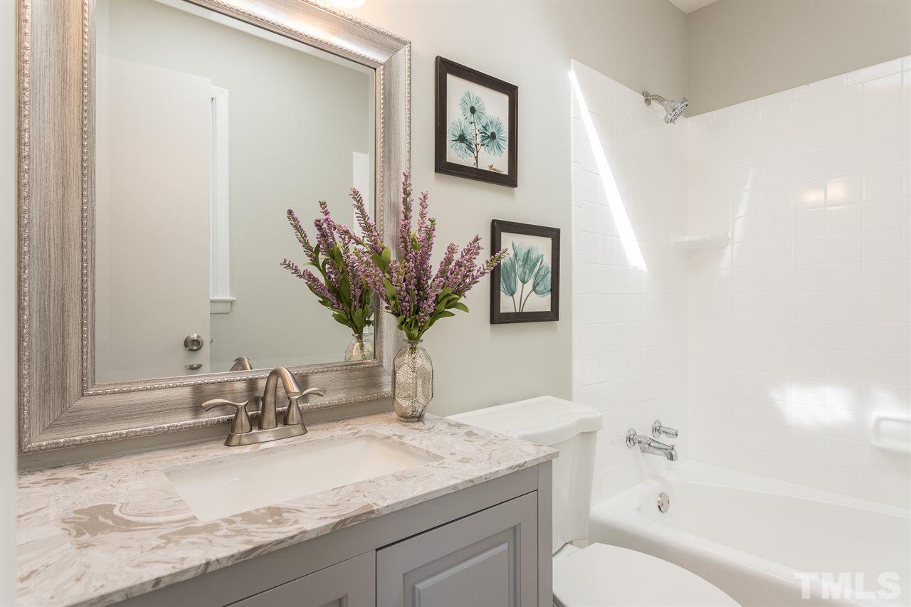 4907 Brentwood Road Durham, NC 27713 - Photo 21 of 27 a bathroom with a granite countertop sink mirror vanity and toilet