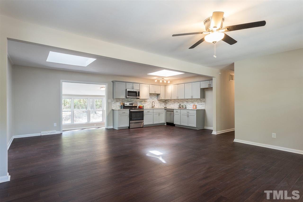 4907 Brentwood Road Durham, NC 27713 - Photo 4 of 27 a view of a kitchen with wooden floor and a window