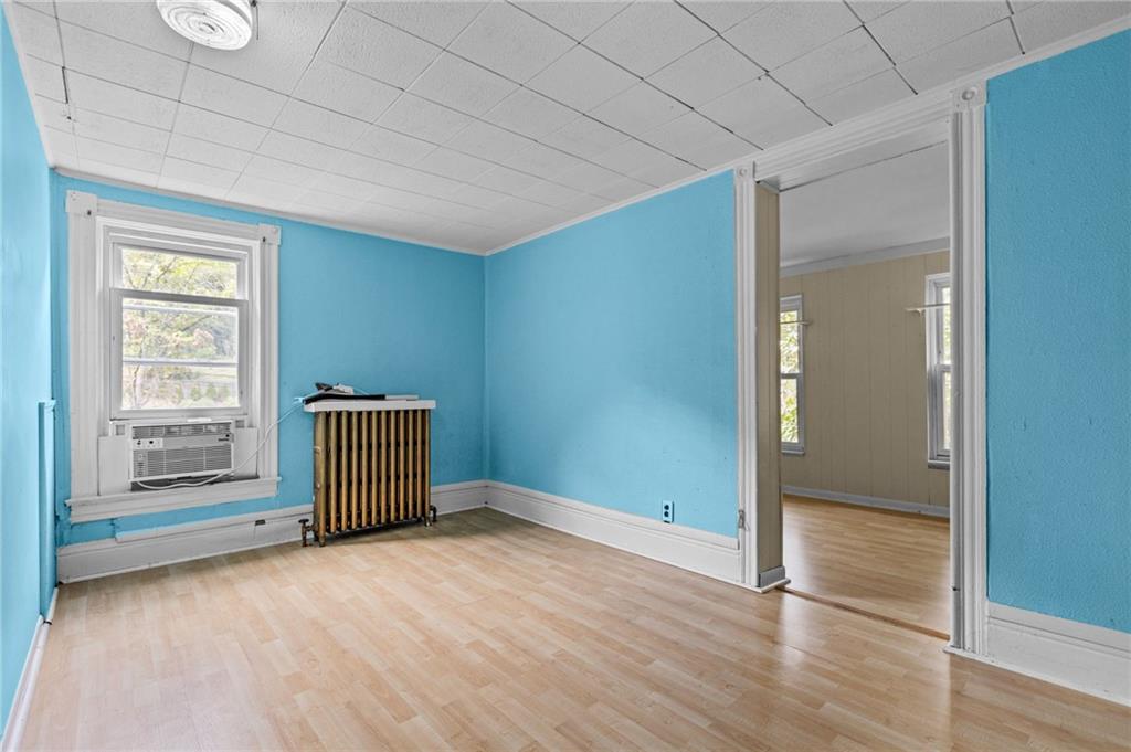 422 Mifflin Road Pittsburgh, PA 15207 - Photo 14 of 18 an empty room with wooden floor and windows