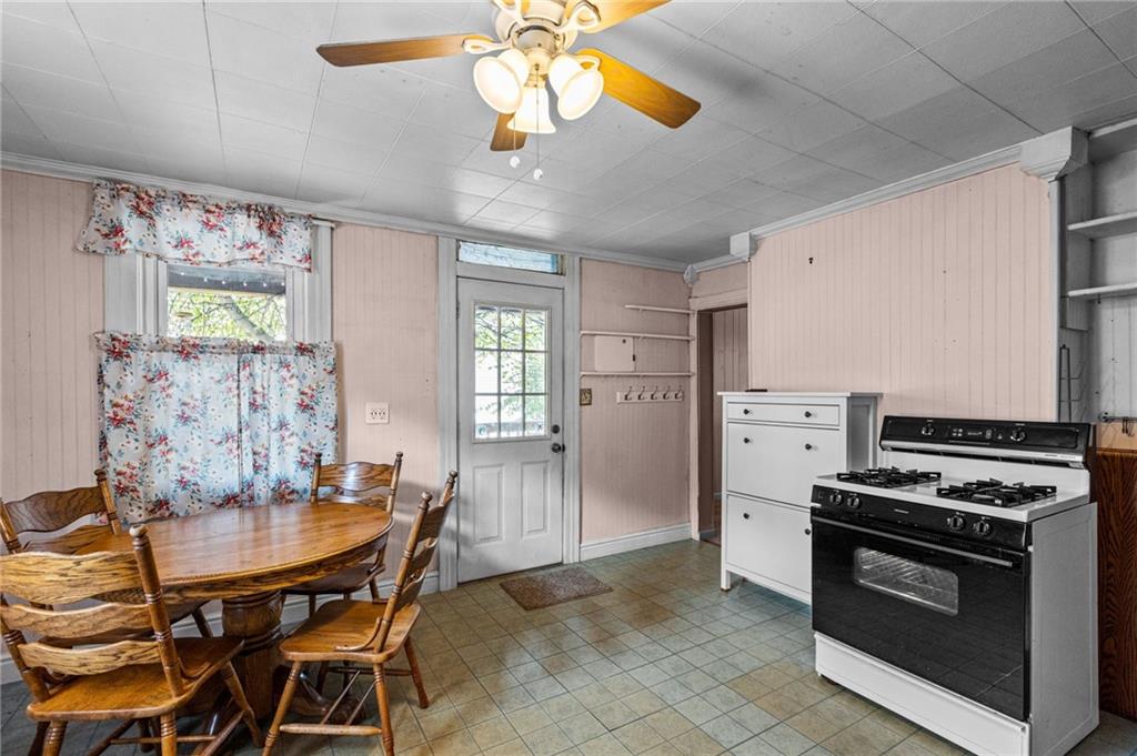 422 Mifflin Road Pittsburgh, PA 15207 - Photo 6 of 18 a kitchen with stainless steel appliances a stove a chimney a dining table and chairs