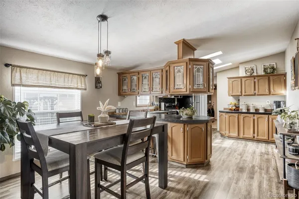 a kitchen with a table chairs stove and cabinets
