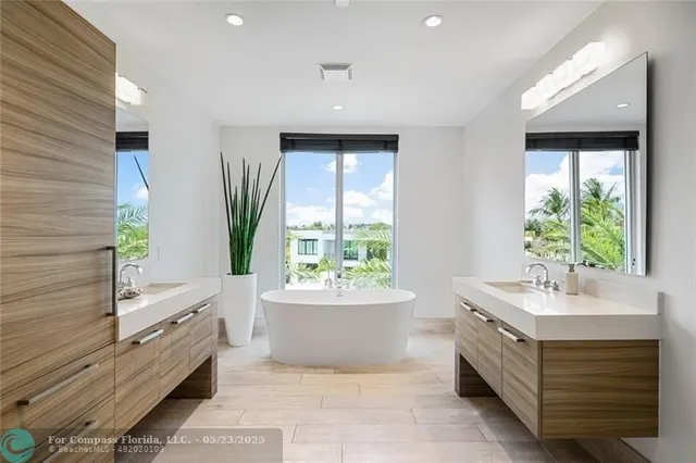 a bathroom with a bathtub sink and mirror
