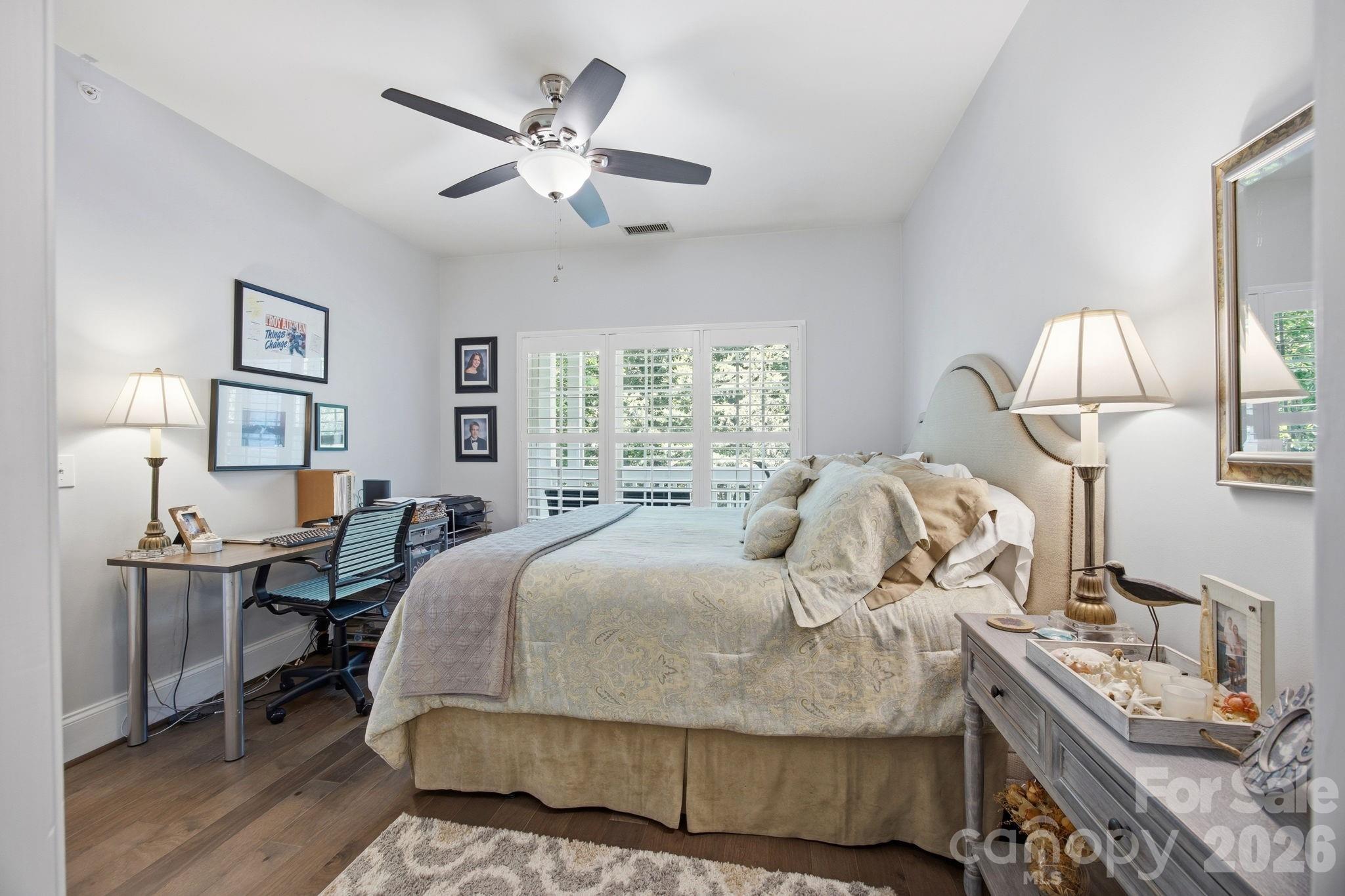 8942 Rosalyn Glen Road Cornelius, NC 28031 - Photo 26 of 47 a bedroom with a bed and wooden floor