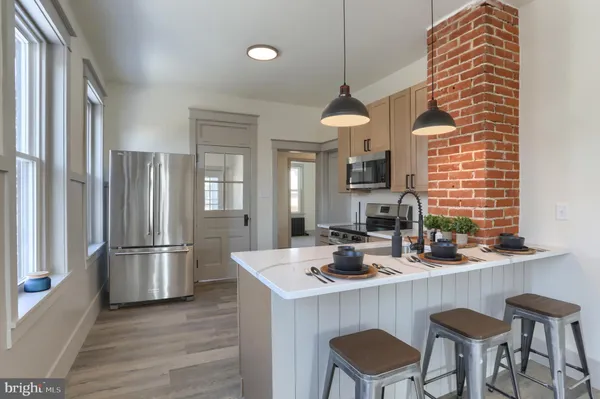 a kitchen with a sink stove and microwave