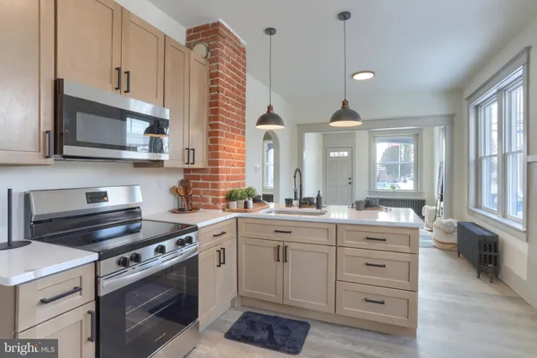 a kitchen with a sink stove and microwave